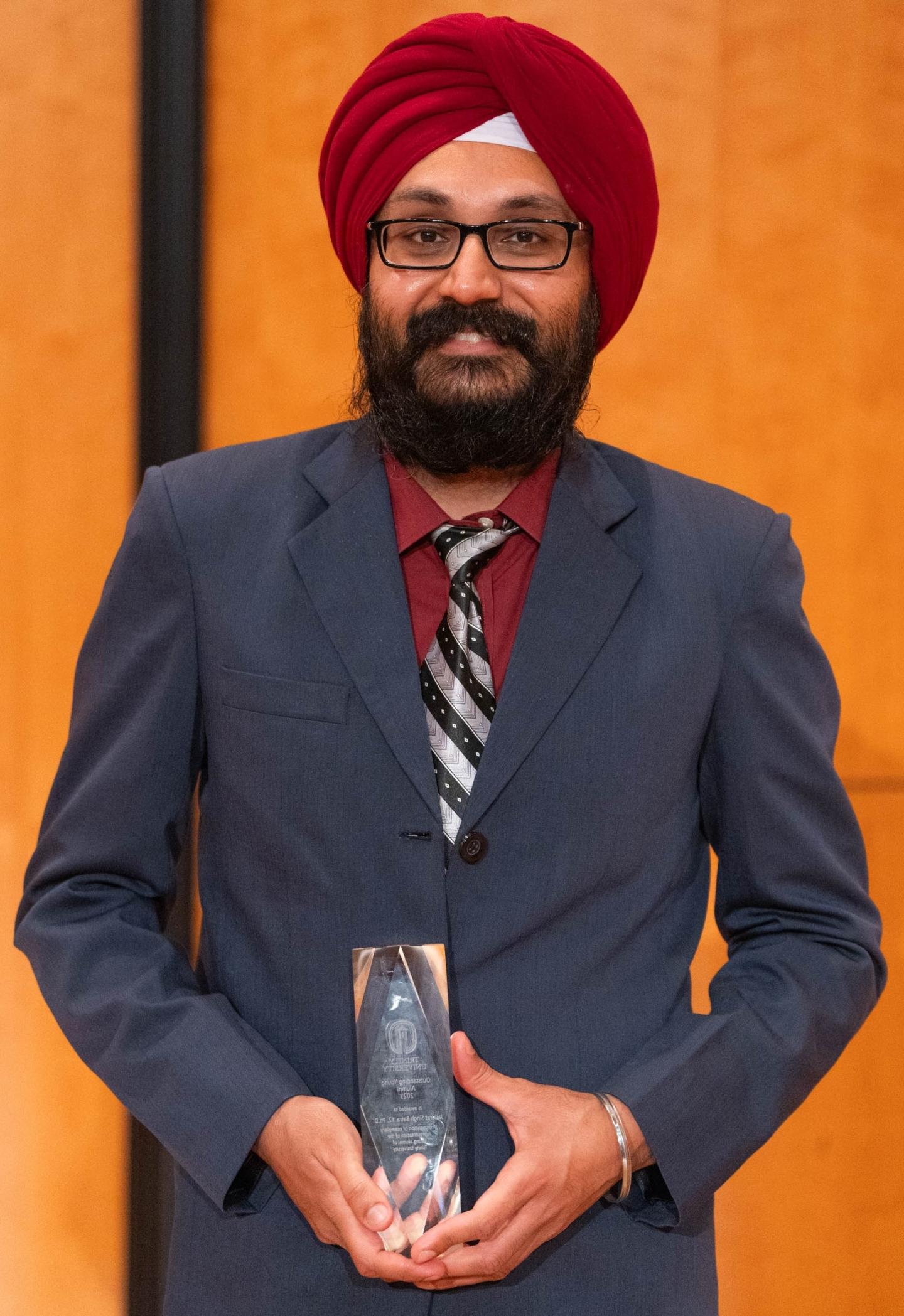 Photo of Jaskirat Singh Batra '12, Ph.D. holding an Alumni Award